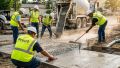 ADA construction specialist verifying accessibility slopes at a California commercial property